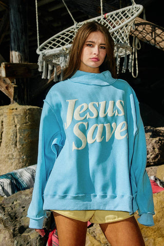 Person wearing a blue hoodie with 'Jesus Save' text in a rustic setting