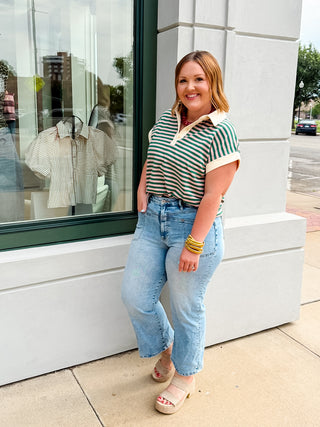 Sporty meets chic in the Country Club Stripe Top. Featuring timeless green and ivory stripes, this lightweight knit top is finished with a crisp contrast collar and rolled sleeve cuffs for a polished yet effortless look. A functional button-front placket and back pleat detail add elevated touches, making it the perfect top for everything from casual Fridays to weekend brunch.