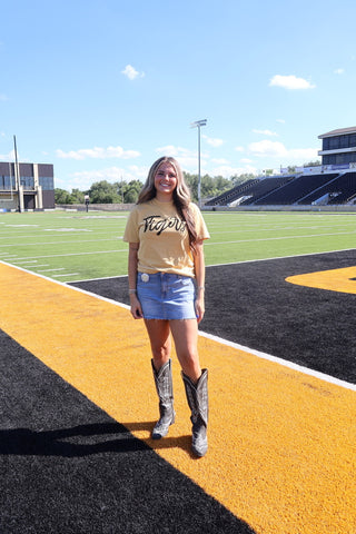 Woman on football field waring a gold tigers tee
