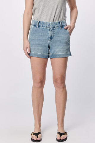 Person wearing light blue denim shorts on a white background