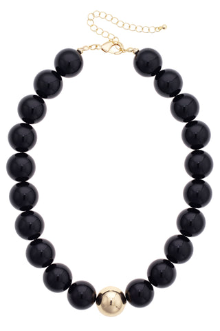 Black beaded necklace with a gold clasp on a white background